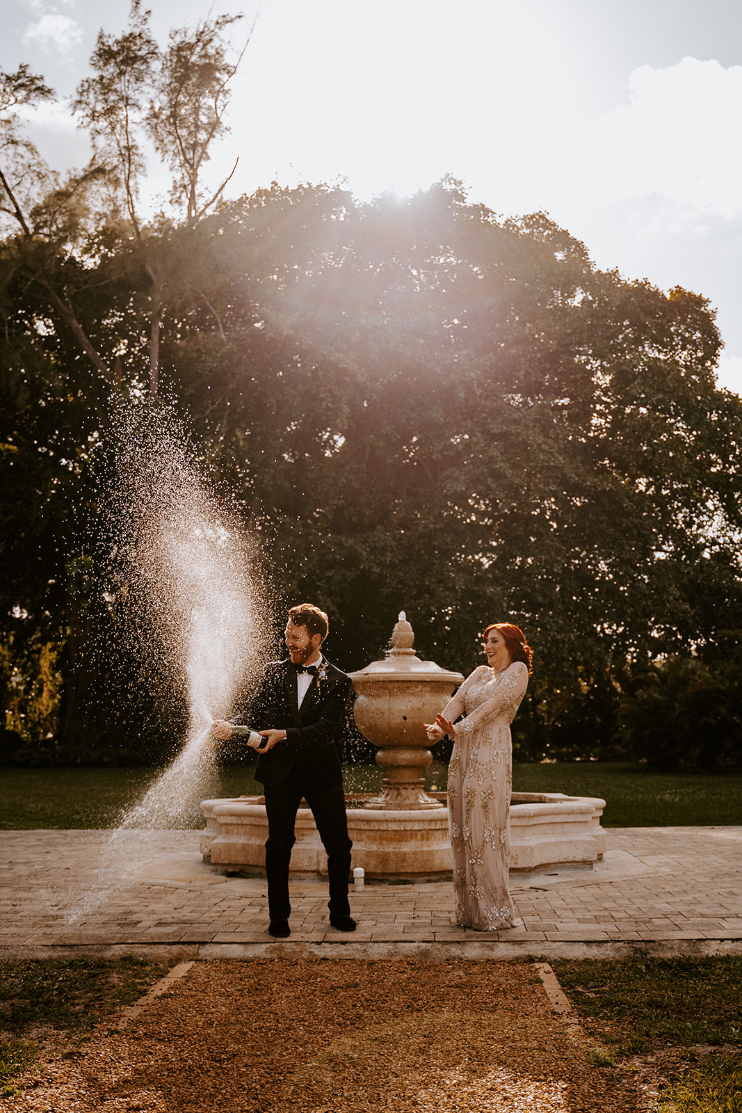Couple pops champagne at their Ancient Spanish Monastery wedding