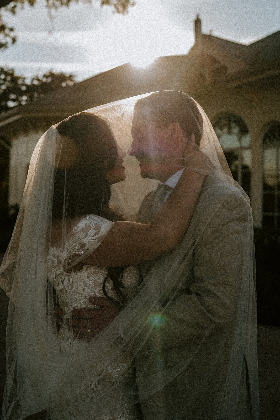 Bride and groom under veil at their Walt Disney World wedding