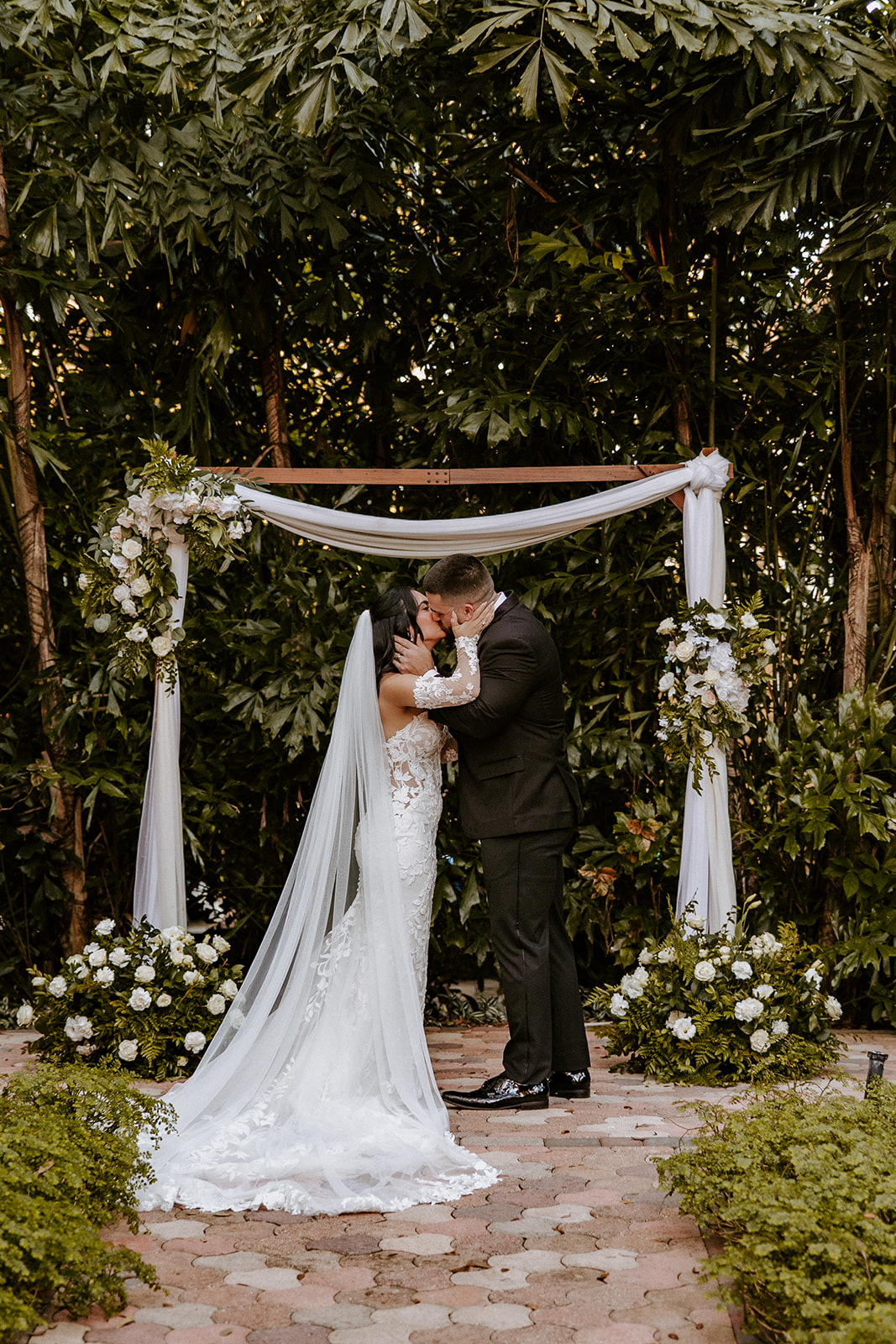 Bride and groom kiss at their Gardens of Weber Manor wedding ceremony